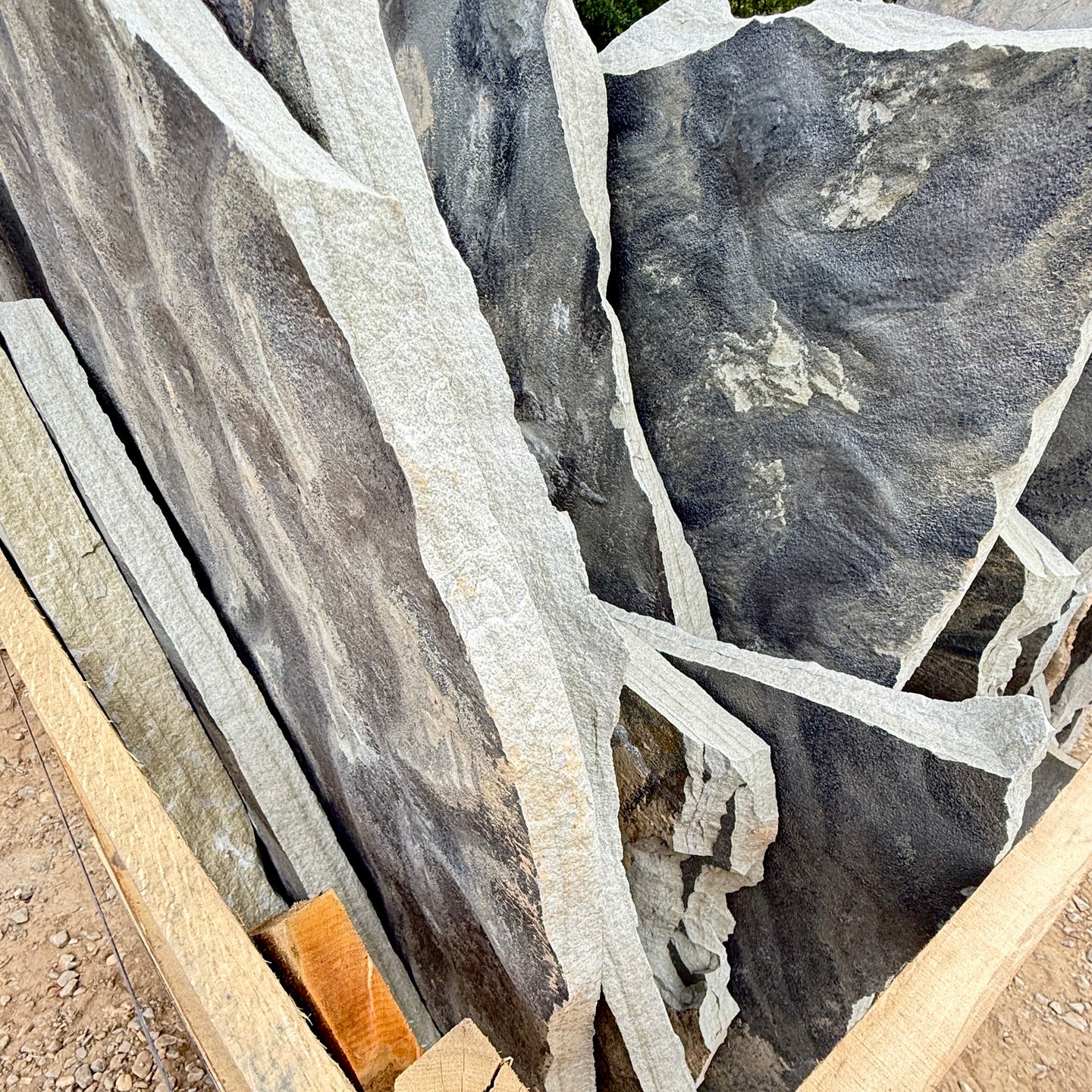 Close-up of large stone slabs with visible texture and color variations.
