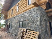 Black Sparkle Thin Veneer Stone installed on a modern cabin surround