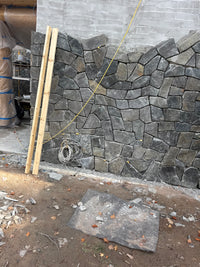 Black Sparkle Thin Veneer Stone installed on a modern cabin surround
