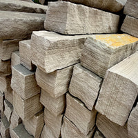 Close-up of Brandy Rubble Edging Stone showing its natural gray color, soft tan variations, and rugged surface.