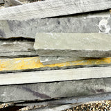 Close-up of Brandy Rubble Edging Stone showing its natural gray color, soft tan variations, and rugged surface.