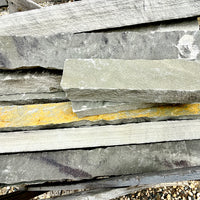 Close-up of Brandy Rubble Edging Stone showing its natural gray color, soft tan variations, and rugged surface.