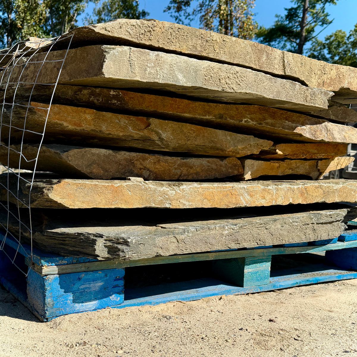 Pallet of Moonlight Blue Large Laydown Flagstone, featuring substantial natural stone pieces for outdoor landscaping projects.