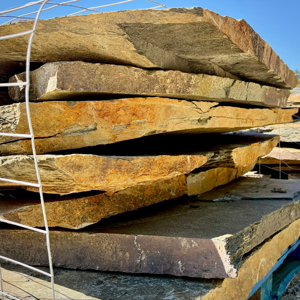 Moonlight Blue flagstone pallet showcasing thick, durable natural granite for landscape and hardscape projects.
