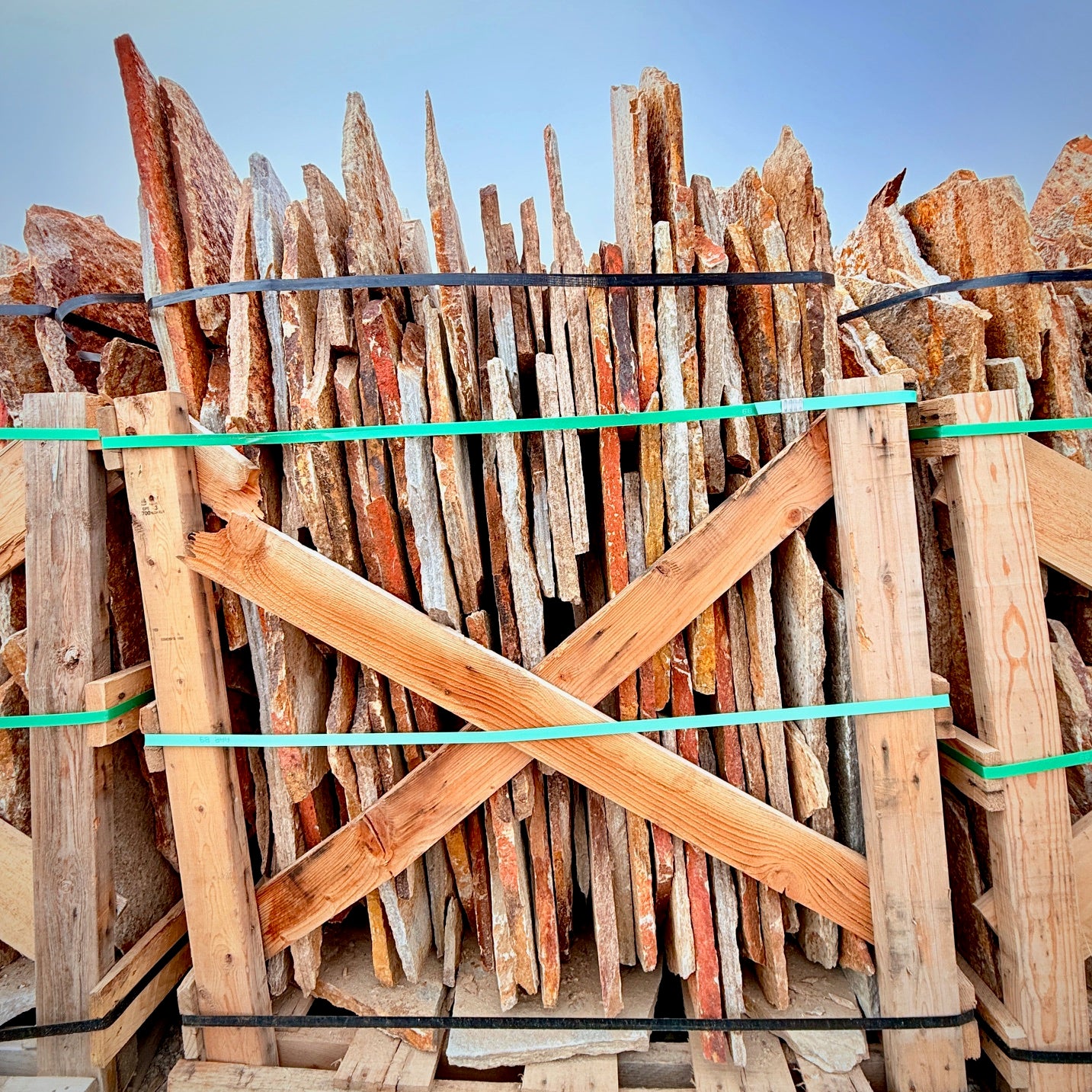 Stack of wooden planks with a blue sky background