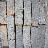 Close-up of Rock Island Lilac edging stone showing natural gray, blue, and lilac color variations.
