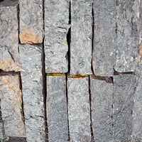 Close-up of Rock Island Lilac edging stone showing natural gray, blue, and lilac color variations.