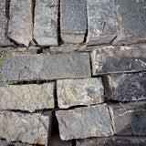 Close-up of Rock Island Lilac edging stone showing natural gray, blue, and lilac color variations.