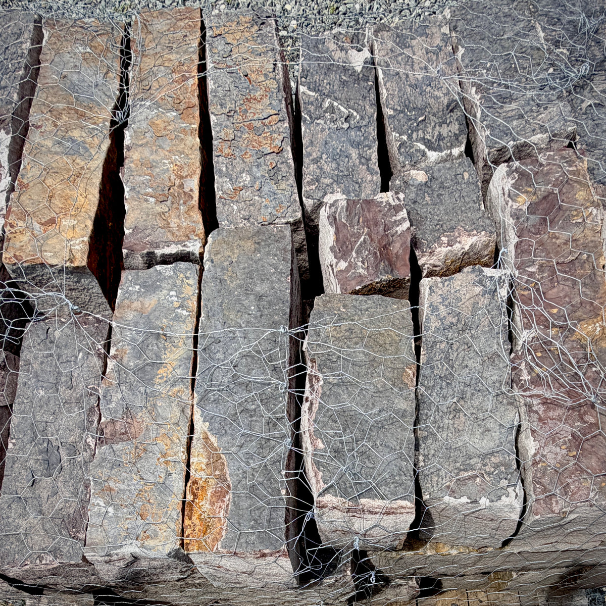 Rock Island Lilac natural stone rubble edging pieces stacked on a 2,000 lb pallet.