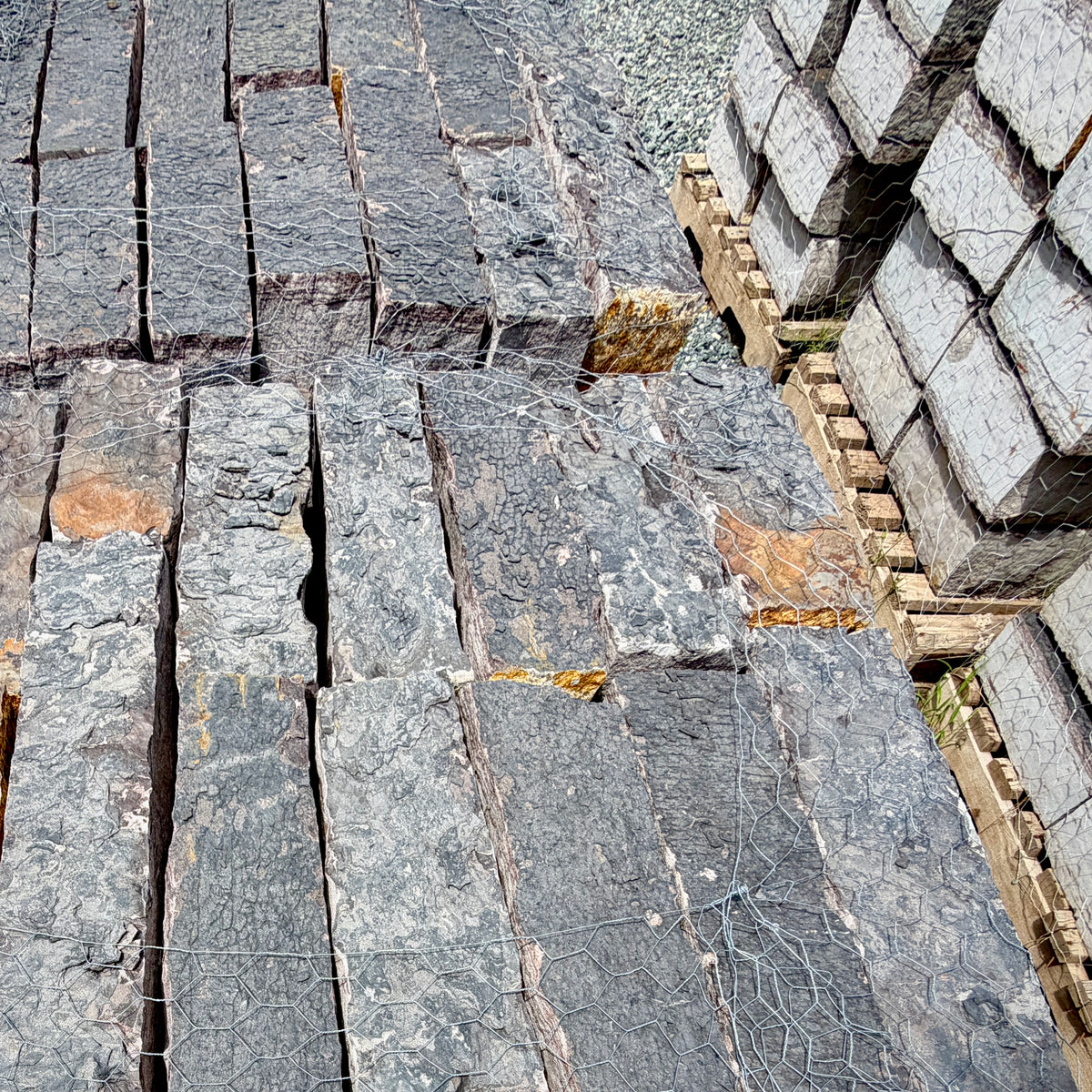 Close-up of Rock Island Lilac edging stone showing natural gray, blue, and lilac color variations.
