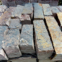 Close-up of Rock Island Lilac edging stone showing natural gray, blue, and lilac color variations.