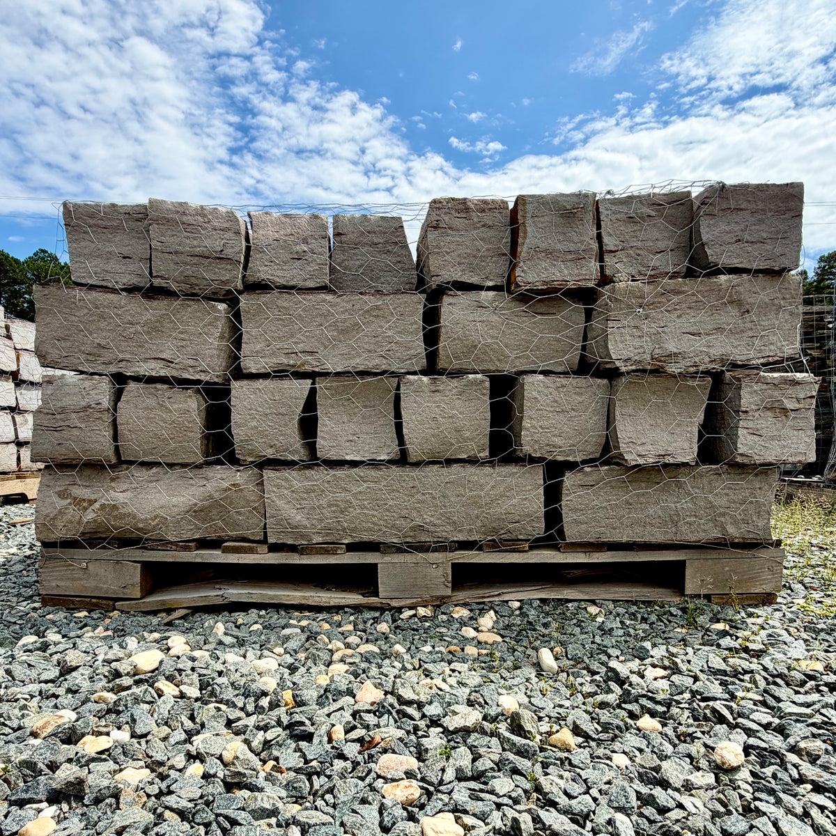 Rock Island Lilac natural stone rubble edging pieces stacked on a 2,000 lb pallet.