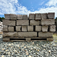 Rock Island Lilac natural stone rubble edging pieces stacked on a 2,000 lb pallet.