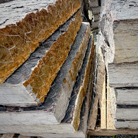 Close-up of Rock Island Lilac step edges with rust-brown cleft faces, gray layers, and natural split texture
