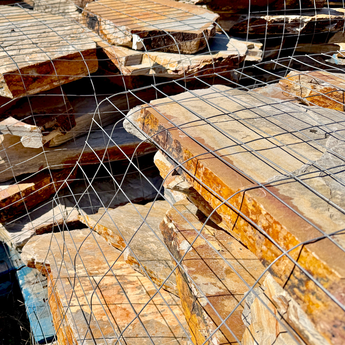 Large-format Summer Tan flagstone pieces ranging from approximately 18 inches to 3 feet.