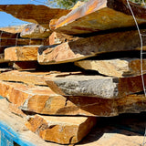 Natural textured surface of Summer Tan granite flagstone for outdoor hardscaping.