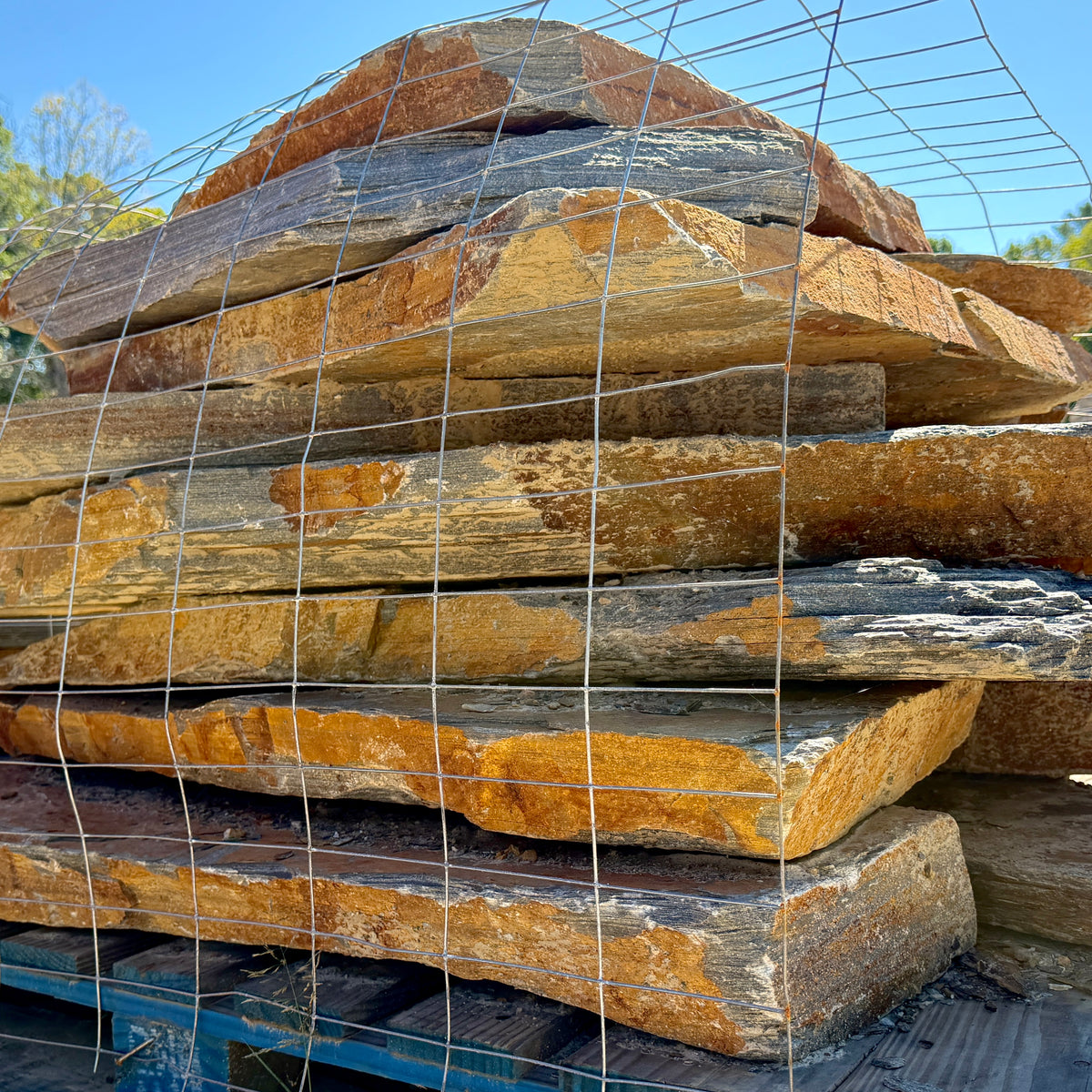 Pallet of large Summer Tan flagstone pieces for patio and landscaping projects.