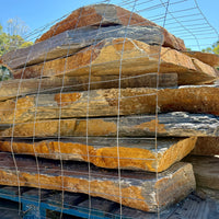 Pallet of large Summer Tan flagstone pieces for patio and landscaping projects.