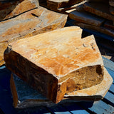 Large Summer Tan natural granite slabs with broad surfaces, irregular edges, and warm golden-brown color variation.