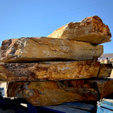 Side view of stacked Summer Tan granite landscape steps showing thick stone profiles and naturally textured edges.